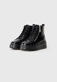 Black leather platform ankle boots with lace-up fronts, side zippers, and studded star decoration on the heel area.