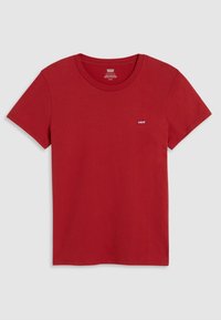 Czerwony bawełniany t-shirt z okrągłym dekoltem, z krótkimi rękawami i małą metką z logo na lewej piersi. Gładka faktura i standardowy krój.
