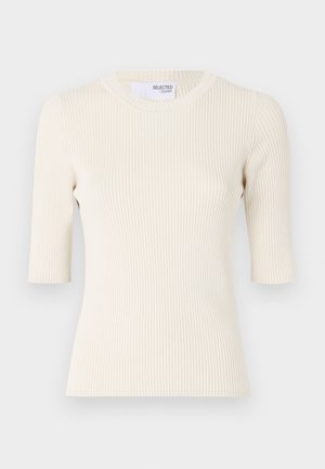 Haut en maille côtelée couleur crème clair avec des manches courtes, un col rond et une silhouette ajustée. Texture lisse avec des rayures verticales.