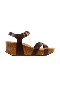 Sandale compensée en cuir marron avec semelle plateforme en liège, bride de cheville ajustable et deux lanières avant croisées sur les orteils.
