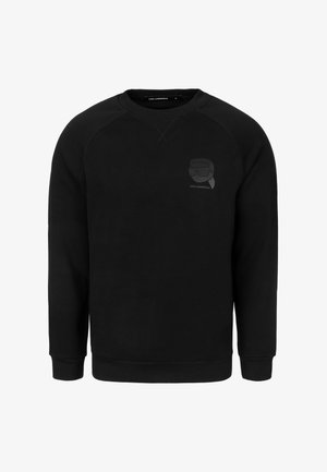 Sudadera negra con cuello redondo, mangas raglán y un logo texturizado en el pecho. Confeccionada con tela suave, presenta puños y dobladillo acanalados.