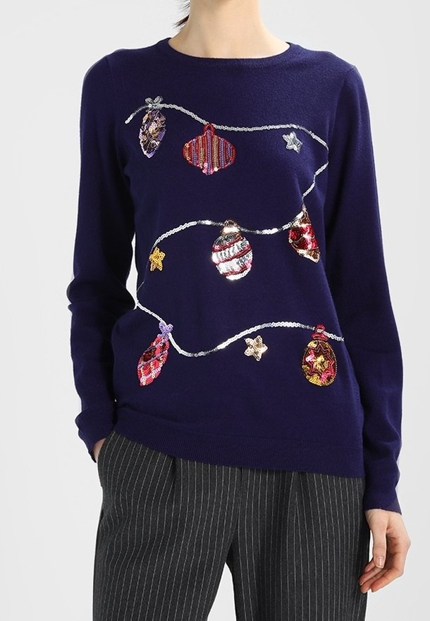 Jersey navy con un diseño embellecido de adornos coloridos y estrellas. La tela suave y los puños acanalados mejoran la textura y la comodidad.