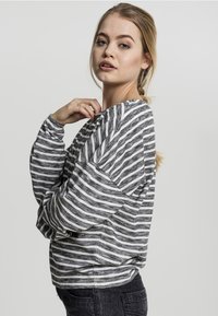 Gestreiftes Langarmoberteil in Grau und Weiß. Mit strukturiertem Stoff und lockerer Passform mit abgesenkten Schultern. Einfaches und lässiges Design.