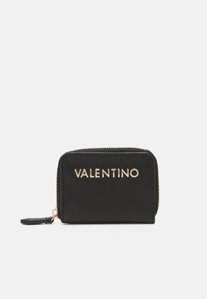Black textured leather wallet with gold "VALENTINO" branding on the front and a zip closure. Compact rectangular shape with side tag detail.