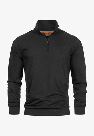 Pull-over noir à demi-zip avec des manches longues, fabriqué en tissu doux. Présente un col montant et des poignets côtelés, avec un logo subtil sur la poitrine.