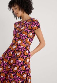 Floral dress featuring a black background, orange and pink flower patterns, short sleeves, and side pockets. Smooth fabric with a fitted bodice.
