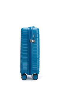 Blue hard-shell luggage with horizontal ridges, a double zipper, combination lock, and four rolling wheels for easy mobility.