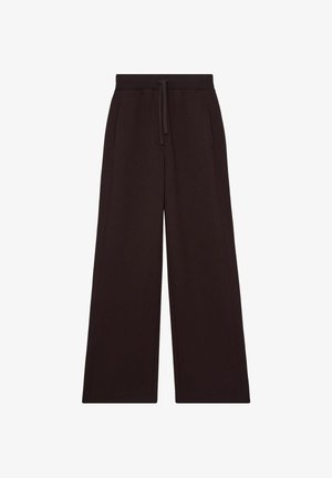 Brede broek van donkerbruine katoen. Voorzien van een trekkoord in de taille en twee zijzakken. Gladde textuur, minimale stikdetails.