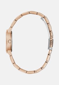 Roosa kuldne metallkell ümmarguse korpuse, kitsase, sileda rihmaga, poleeritud detailide ja ühe krooniga paremal küljel.