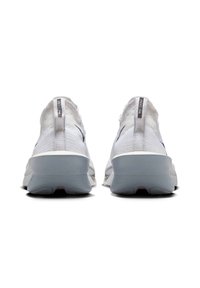 White athletic shoes with a knit upper, padded collar, grey sole, and a pull tab at the back. The design features minimalistic accents.
