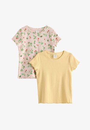 Dwie krótkie, prążkowane koszulki z krótkim rękawem, jedna w jednolitym, jasnożółtym kolorze, druga jasnoróżowa z nadrukiem zielonych liści i czerwonych jagód, obie z falowanymi brzegami.