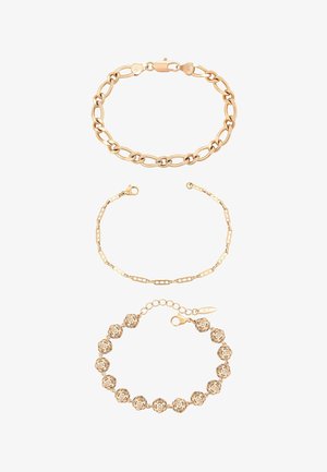 Trzy złote bransoletki w różnych stylach: masywne owalne ogniwa, delikatne prostokątne ogniwa oraz połączone kuliste koraliki z zapięciem.