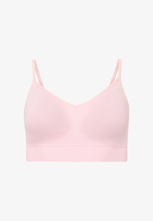 Lichtroze draadloze beha met dunne verstelbare bandjes en naadloze cups op een witte achtergrond.