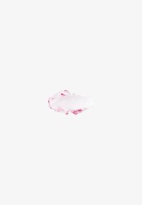 Creamy pink cosmetic swatch with a soft texture, blending from opaque white into a pastel pink hue, against a plain white background.
