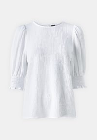 Blusa bianca con texture, maniche a sbuffo e polsini arricciati, con scollatura rotonda e tessuto morbido.