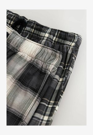 Kárované lounge nohavice v čiernej, šedej a bielej farbe. Mäkká tkanina s elastickým pásom a voľným strihom, ktorý obsahuje textúrovaný vzor.