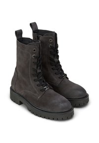 Dunkelgraue Schnür-Stiefeletten aus Wildleder mit dicken Gummisohlen und Zuglaschen an der Rückseite, seitliche Schräge auf weißem Hintergrund.