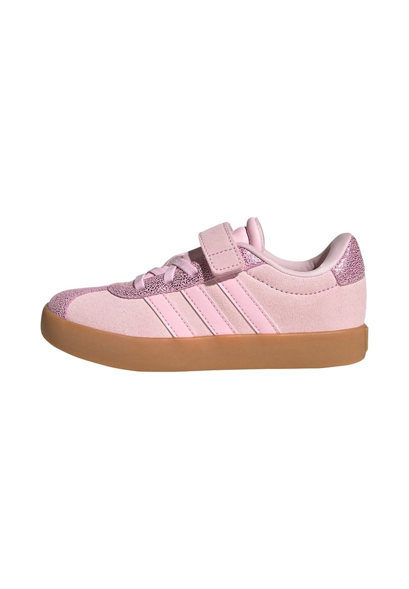 Pink suede sneaker with glittery accents, featuring a Velcro strap, lace-up closure, and rubber sole. Three stripes detail on the side.