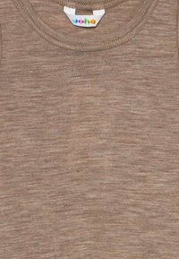 Brun, texturerad stickad tyg med rundad halsringning och en vit klädlapp med flerfärgad text centrerad inuti kragen.