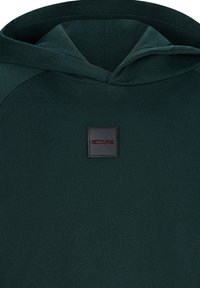 Felpa con cappuccio di un verde scuro, realizzata in tessuto testurizzato, dotata di cappuccio e di un'etichetta quadrata nera con la scritta "RETOUR" in lettere rosse sul davanti.