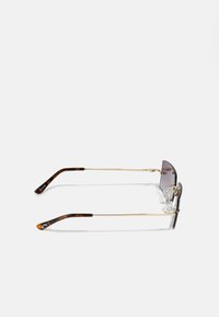 Sunglasses with a gold metal frame, gray tinted lenses, and tortoiseshell temple tips. Features adjustable nose pads for comfort.
