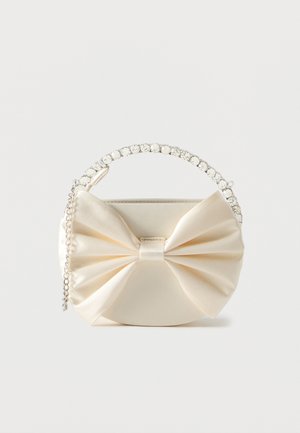 Small ivory satin handbag with large decorative bow, rhinestone handle, and silver chain strap on white background.