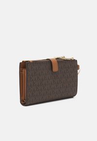 Portafoglio marrone con un motivo texture, dotato di un accento in pelle beige, hardware dorato, chiusura con zip e più scomparti per carte all'interno.