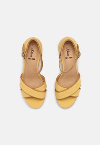 Yellow fabric sandals with crisscross straps, ankle buckle, and soft foam insole. Features a smooth texture and flat sole. Size 37.