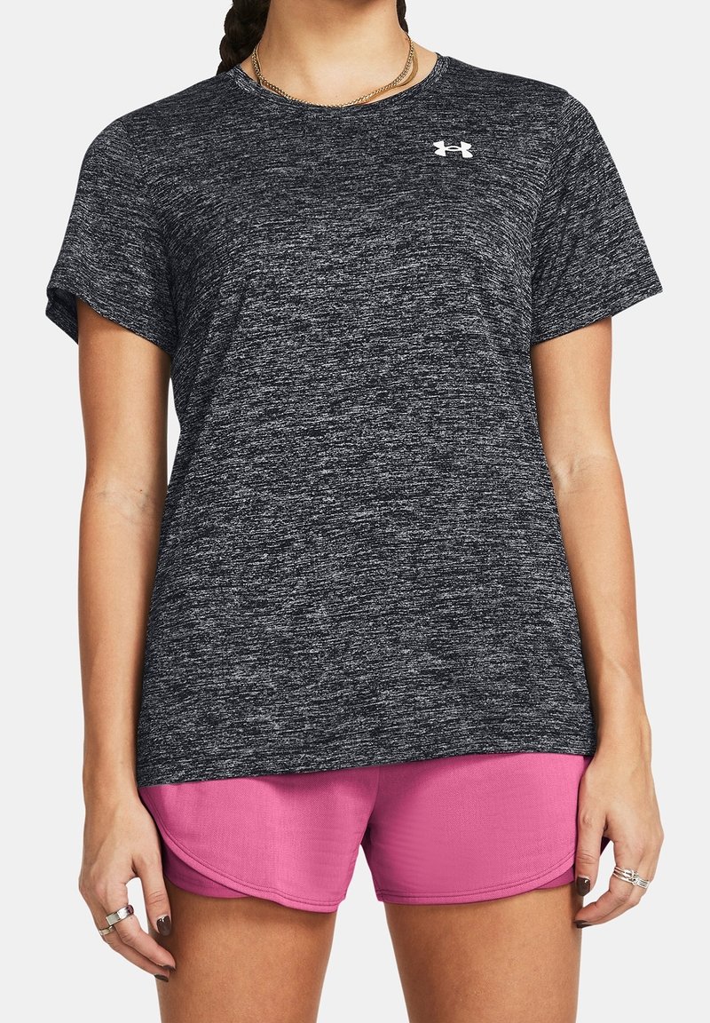 Black heathered athletic t-shirt with short sleeves and a round neck, featuring a small white logo on the chest, paired with pink shorts.