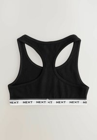 Zwarte sportbeha met racerback-ontwerp, gemaakt van zachte stof. Heeft een witte merkband met de tekst 'NEXT'. Glad oppervlak.