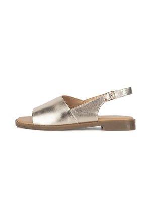 Metaliczny złoty sandał na pasek z odkrytym noskiem, płaską podeszwą i regulowanym paskiem z klamrą, charakteryzujący się gładką skórzaną fakturą i minimalistycznym stylem.