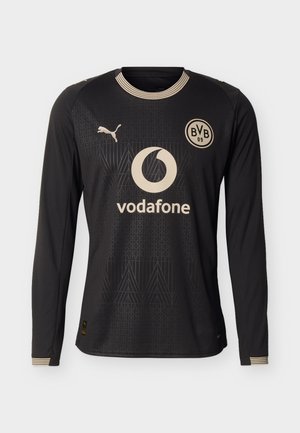 Zwart voetbalshirt met lange mouwen, met beige Vodafone-logo, Puma-embleem en BVB 09-wapen, met subtiele geometrische patronen en gestreepte kraag.