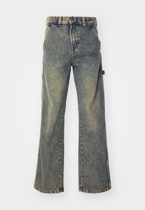 High-waisted wide-leg denim jeans in a faded blue wash, featuring five pockets, belt loops, and a raw hem with visible stitching details.