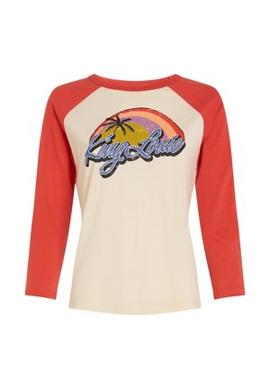 Kremowa koszula z czerwonymi rękawami raglanowymi, z nadrukiem w stylu retro przedstawiającym palmy i słońce w odcieniach żółci, różu i pomarańczy.