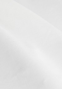 Tissu textile en pur blanc, présentant une surface lisse et légèrement texturée avec un subtil éclat. Tombé doux sans motifs visibles.