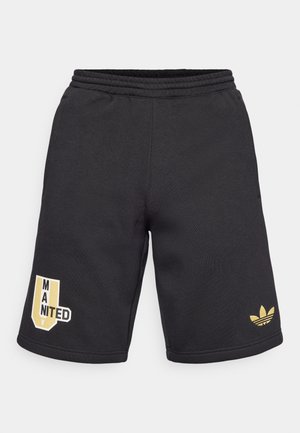 Černé sportovní šortky z měkké tkaniny, se zlatým logem Adidas a grafikou "MANITED". Elastický pas s šňůrkou pro úpravu velikosti.
