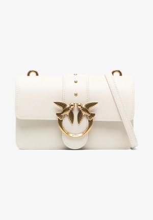 White leather crossbody bag with a flap closure, gold-tone bird motif hardware, and studs on the front. Features a detachable strap.