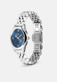 Silver stainless steel watch with a round blue patterned dial, Roman numerals, and a polished bracelet strap. Features secure clasp.