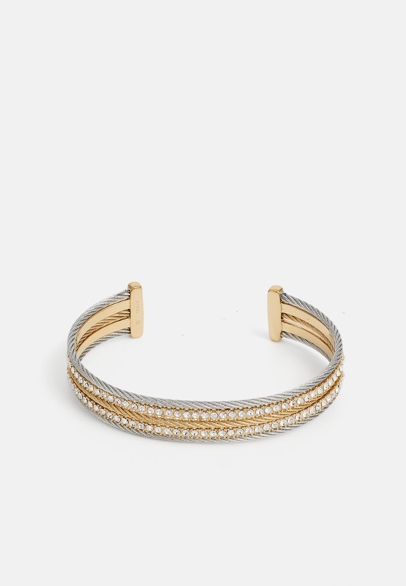 Cuff bracelet featuring intertwined silver and gold metal, embellished with a row of clear gemstones along the center. Smooth texture, open design.