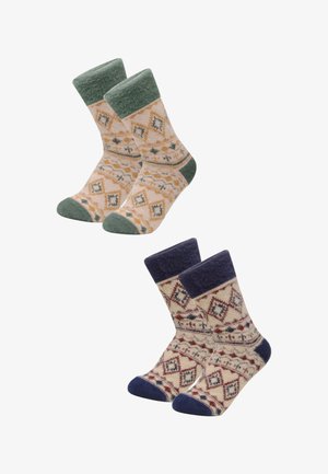 Zwei Paar gemusterte Socken: ein Paar in Pfirsich und Grün mit geometrischen Mustern, das andere in Creme und Marineblau mit ähnlichen Motiven und strukturierten Bündchen.