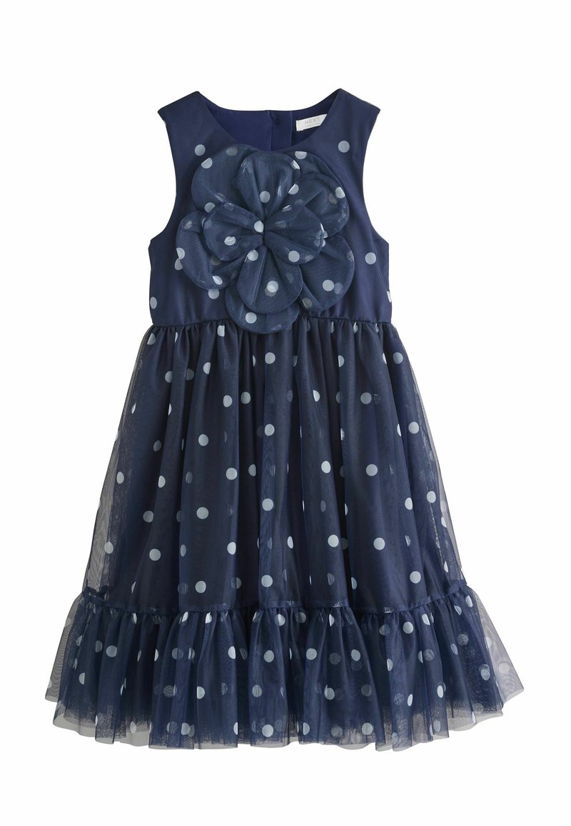 Robe sans manches bleu marine avec une grande fleur texturée et un motif à pois. Surcouche en tulle et ourlet à volants ajoutent du volume et des détails.