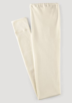 Leggings beige clair en tissu doux et extensible. Ils présentent une finition lisse et un design simple, sans couture, sans motifs ni accents.