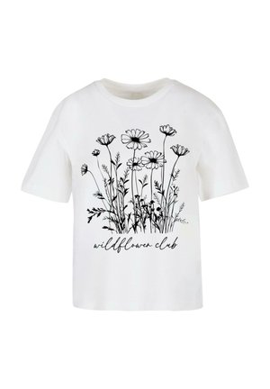 T-shirt blanc à manches courtes, orné d'un motif floral noir et du texte "wildflower club" en police cursive en bas.