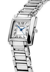 Montre carrée en argent avec un cadran blanc, des chiffres romains, des aiguilles bleues et un bracelet en acier inoxydable. Marque "Sekonda" affichée.