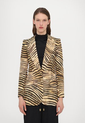 Tiger-striped blazer in beige and black, featuring a notched lapel, single button closure, and two front pockets. Smooth fabric texture.