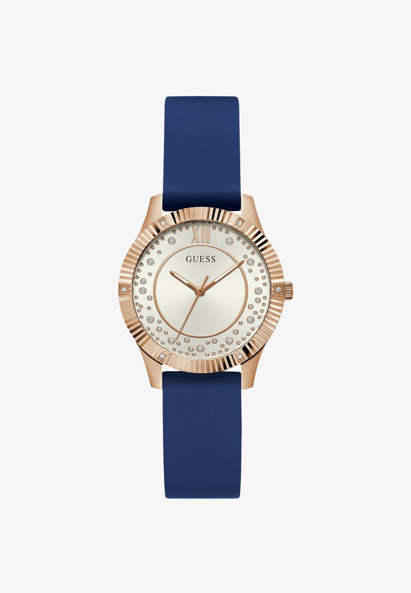 Roosa kuldne kell sinise silikoonsiduriga, ümmargune nägu ja kristallaktsentidega hõbedasel kuval. Tüüpiline XII numbritähis loksutab ülaosas.