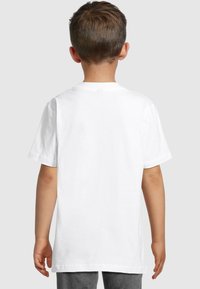 White cotton t-shirt with short sleeves, crew neck, and a plain back design. Features a relaxed fit and smooth texture.