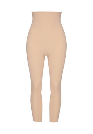 Leggings beige modelants avec une taille haute, texture lisse et design sans couture. Présente une ouverture à l'entrejambe pour plus de confort.