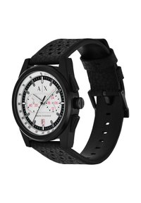 Reloj cronógrafo negro con una esfera blanca y roja, gran caja negra y una correa de cuero negro texturizado con perforaciones.
