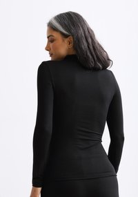 Long-sleeve black top made of stretchy fabric, featuring a high neck and fitted design, smooth texture, and minimalist style.